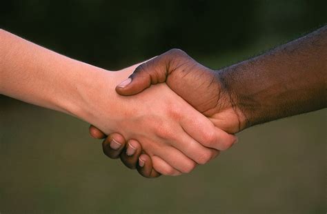white and black man shaking hands