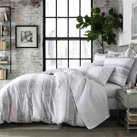 white comforter with grey