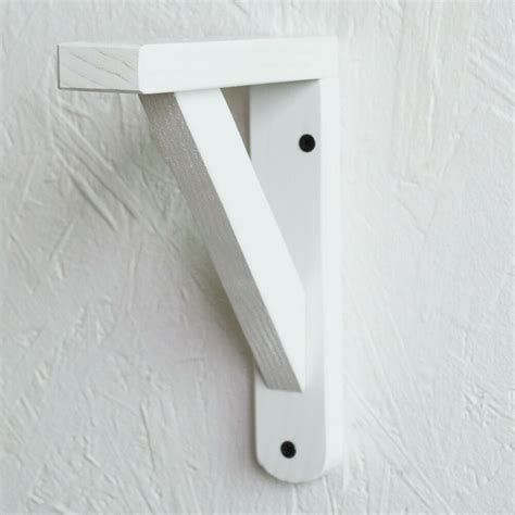 white wooden shelves with brackets