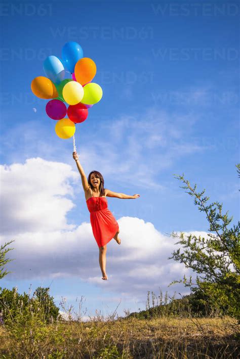 woman flying with balloons