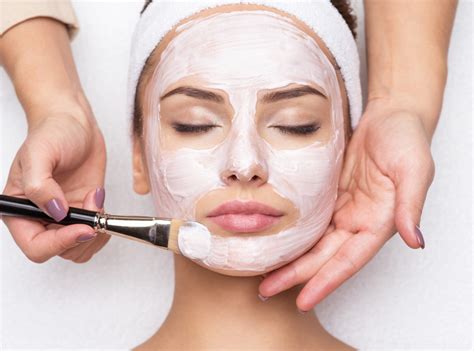 women applying facial mask