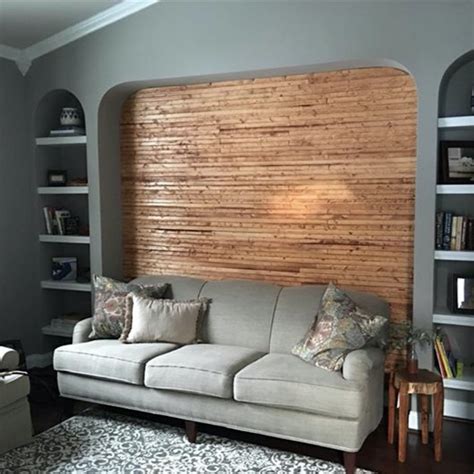 A wood accent wall adds warmth to this bedroom