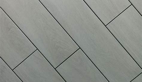 Wet grout lines in dark pearl grey between long porcelain tile planks