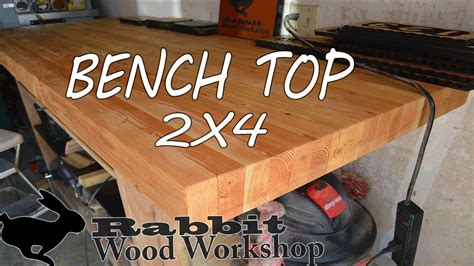 A ten foot long shakerstyle workbench in walnut and butternut with a