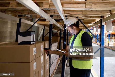 Workers Using GPS Tracker in Warehouse