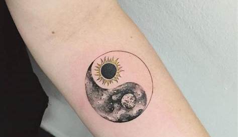 Sun-moon Yin Yang tattoo on the forearm.